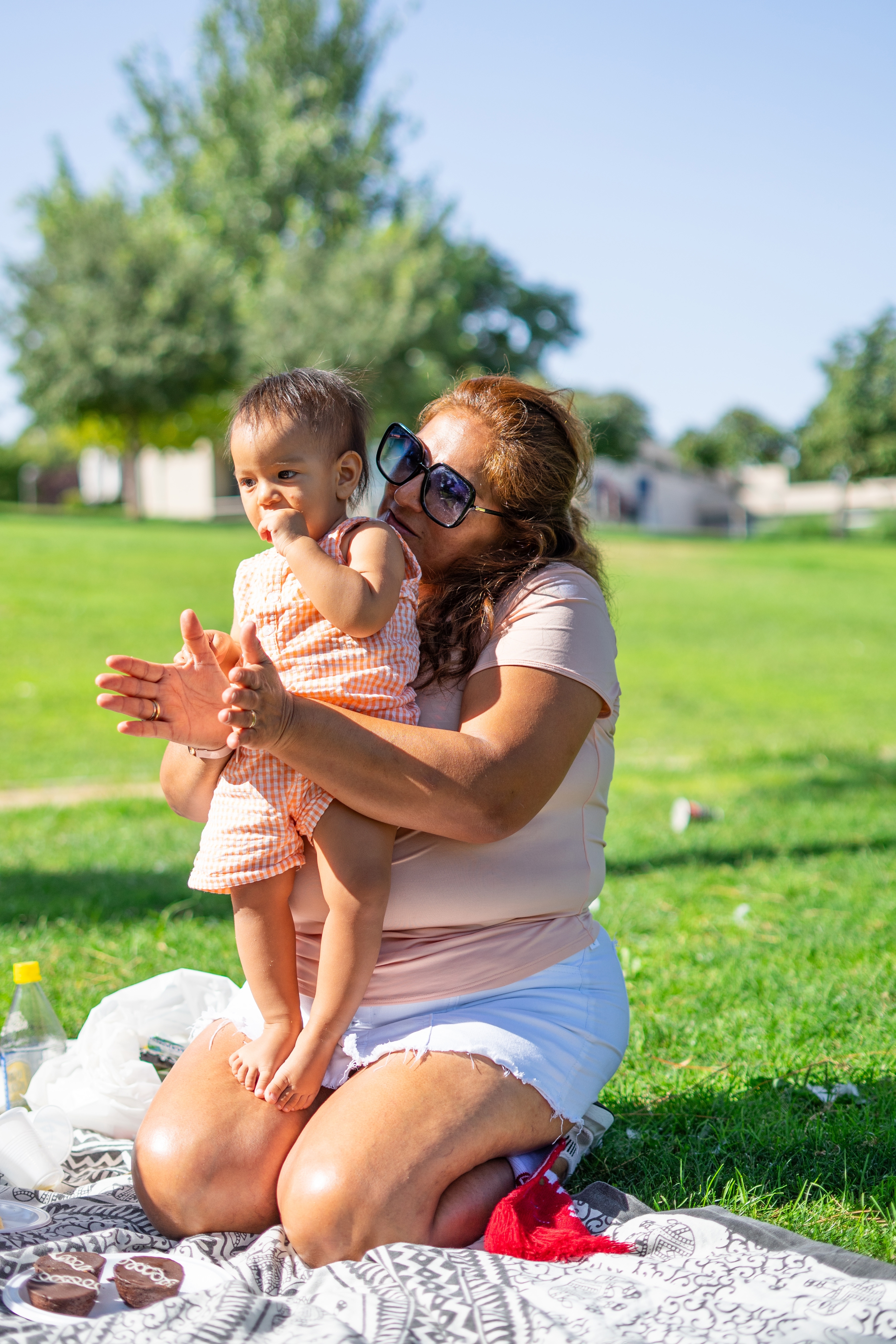 caregiver teaching toddler how to clap